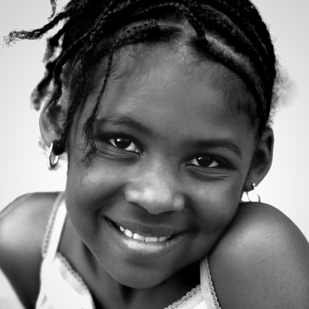 Young girl looking into the camera. Black and white photo.